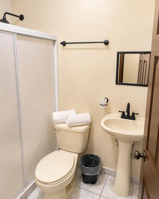 Bathroom with shower, sink and towels