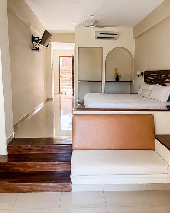 Sitting area with a built-in sofa and wooden step inside a room
