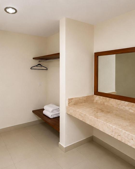 Vanity with mirror and closet with hangers