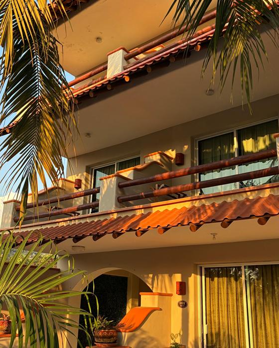 Wooden balconies and tile roofs at Hotel Bonito in afternoon light