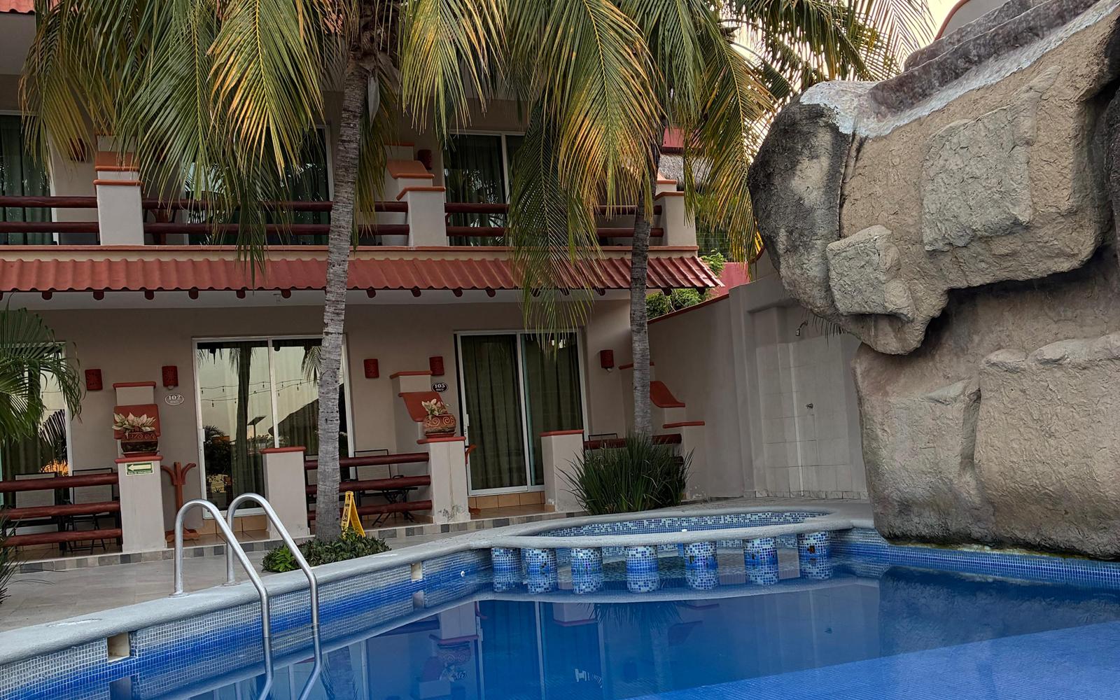 Hotel Bonito pool with palm trees and the room balconies