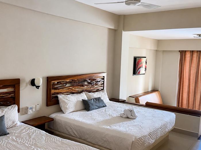 Spacious King Room with curtains and balcony door