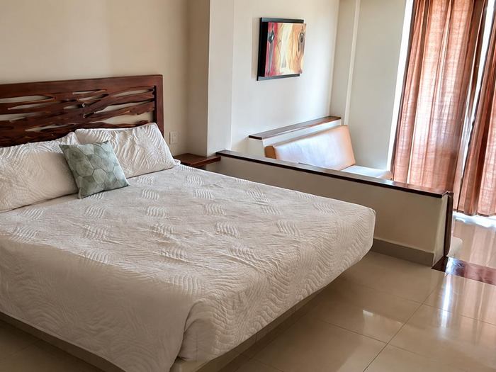 King-size bed with wooden headboard